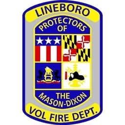 Lineboro Volunteer Fire Department patch featuring "Protectors of the Mason-Dixon" with American flag, Maryland flag, and fire department emblems in a blue and yellow shield design.