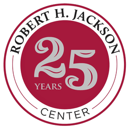 Robert H. Jackson Center 25 Years anniversary logo featuring a silver number 25 on a burgundy circular background with text around the border.