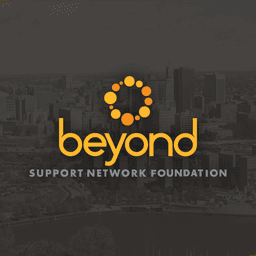 Beyond Support Network Foundation logo with yellow circular design overlaid on a grayscale cityscape background with orange curved border element.