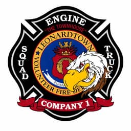 Fire department patch for Leonardtown Engine Company 1, featuring "The Townhouse" with a white eagle, squad and truck designations, and a red banner at the bottom.