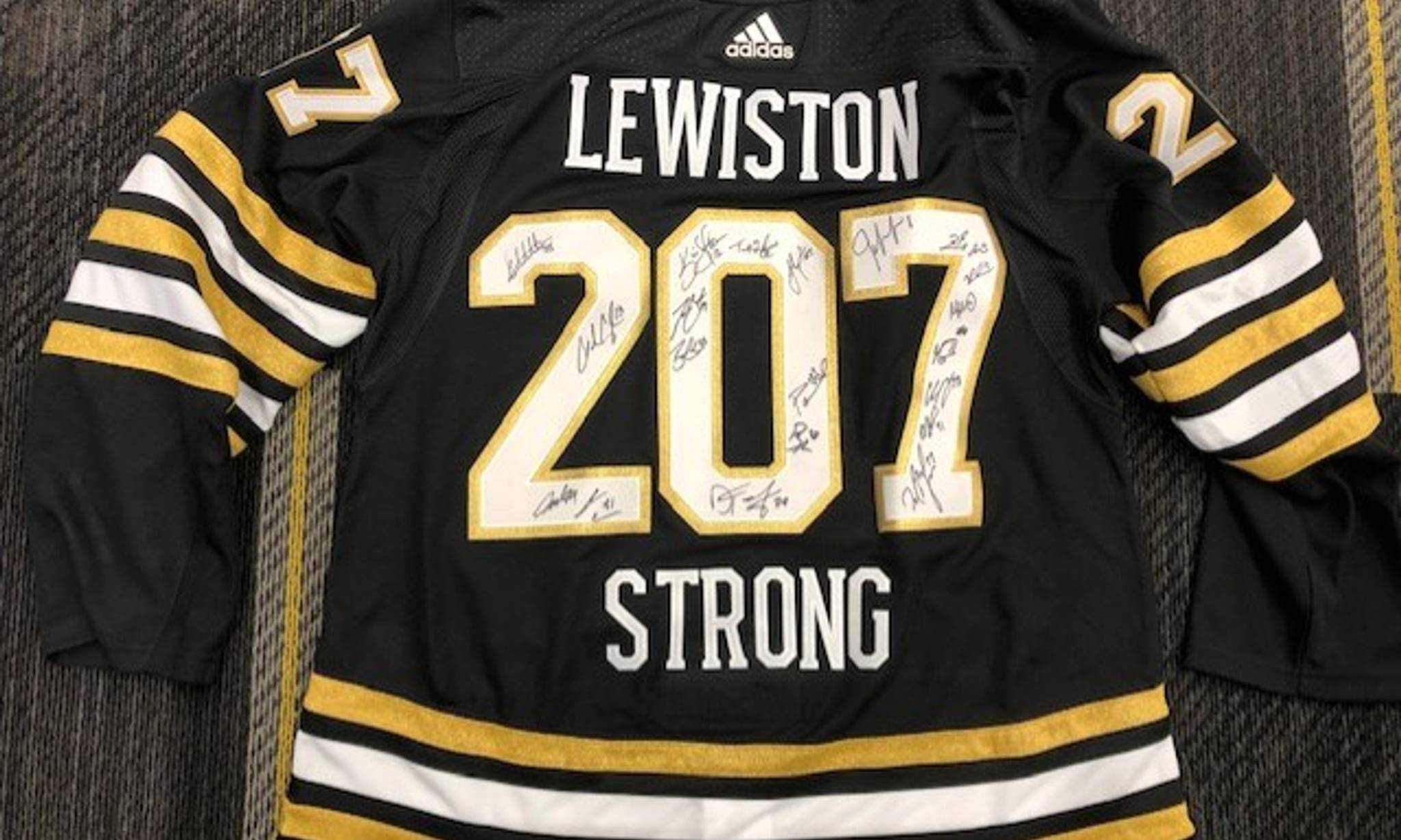 Team Signed Lewiston Strong Jersey event banner