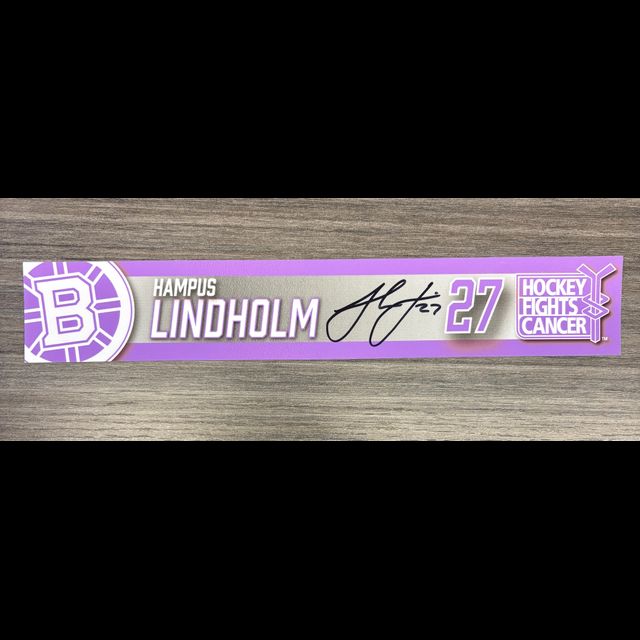 Hampus Lindholm signed hockey locker nameplate in purple, number 27, Hockey Fights Cancer theme