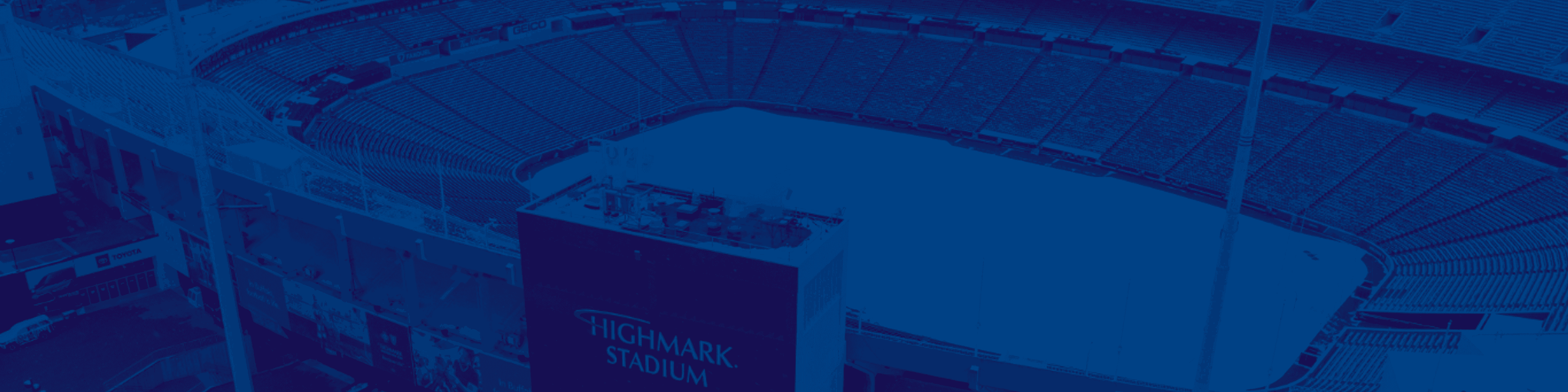 Aerial view of Highmark Stadium with blue tint overlay, showing the ice rink and seating areas surrounded by modern architectural structures.