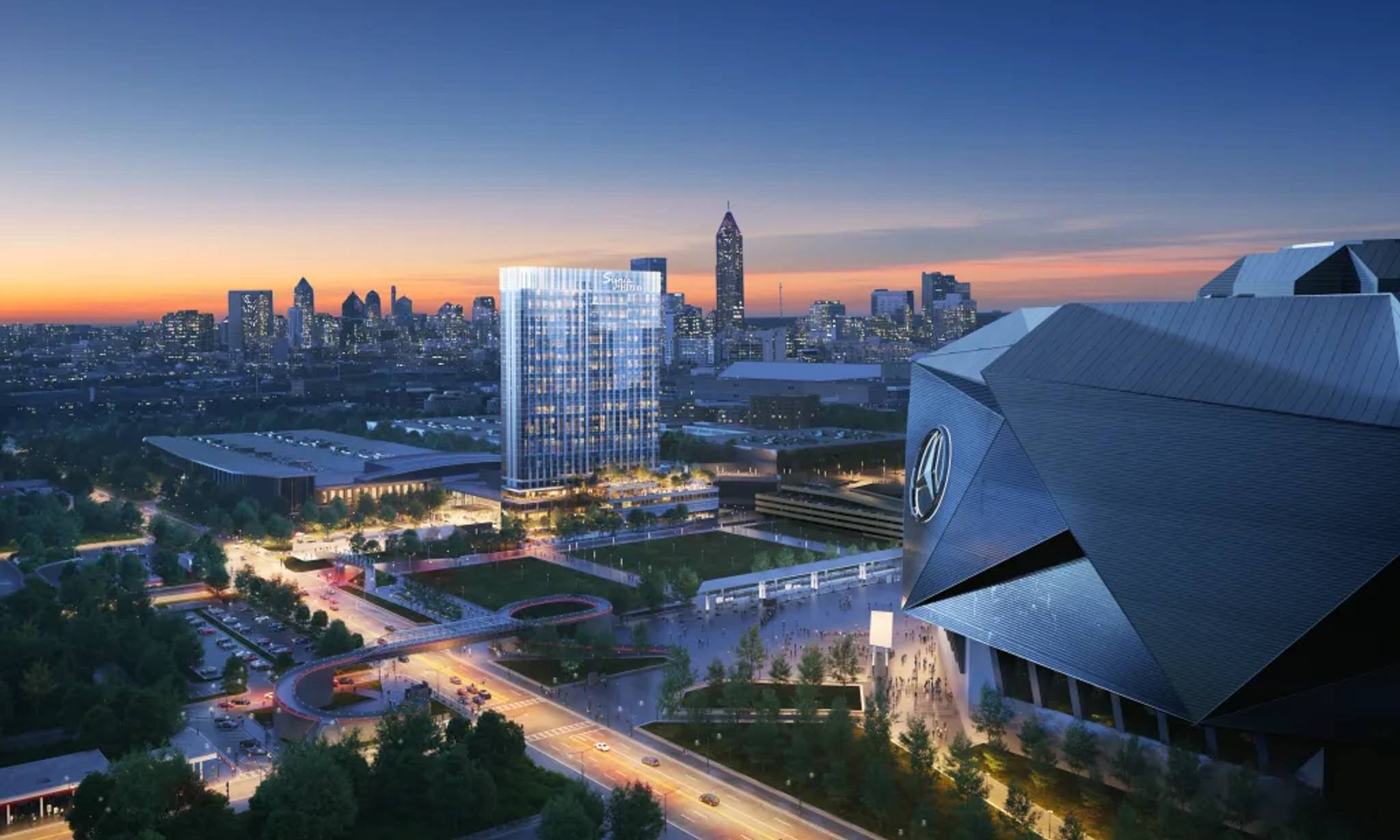 Twilight cityscape featuring modern architecture with illuminated buildings, a distinctive Mercedes-Benz logo structure in the foreground, landscaped grounds, and a skyline of skyscrapers against a colorful sunset sky.