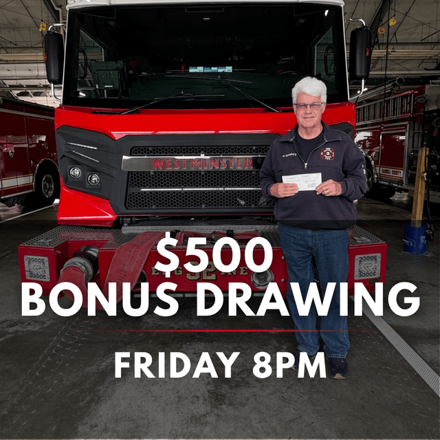 Firefighter holds check in front of red Westminster fire truck in garage for $500 bonus drawing Friday 8pm promotional event.
