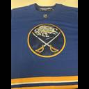 Buffalo Sabres blue hockey jersey with team logo featuring crossed swords and buffalo emblem, NHL patch visible